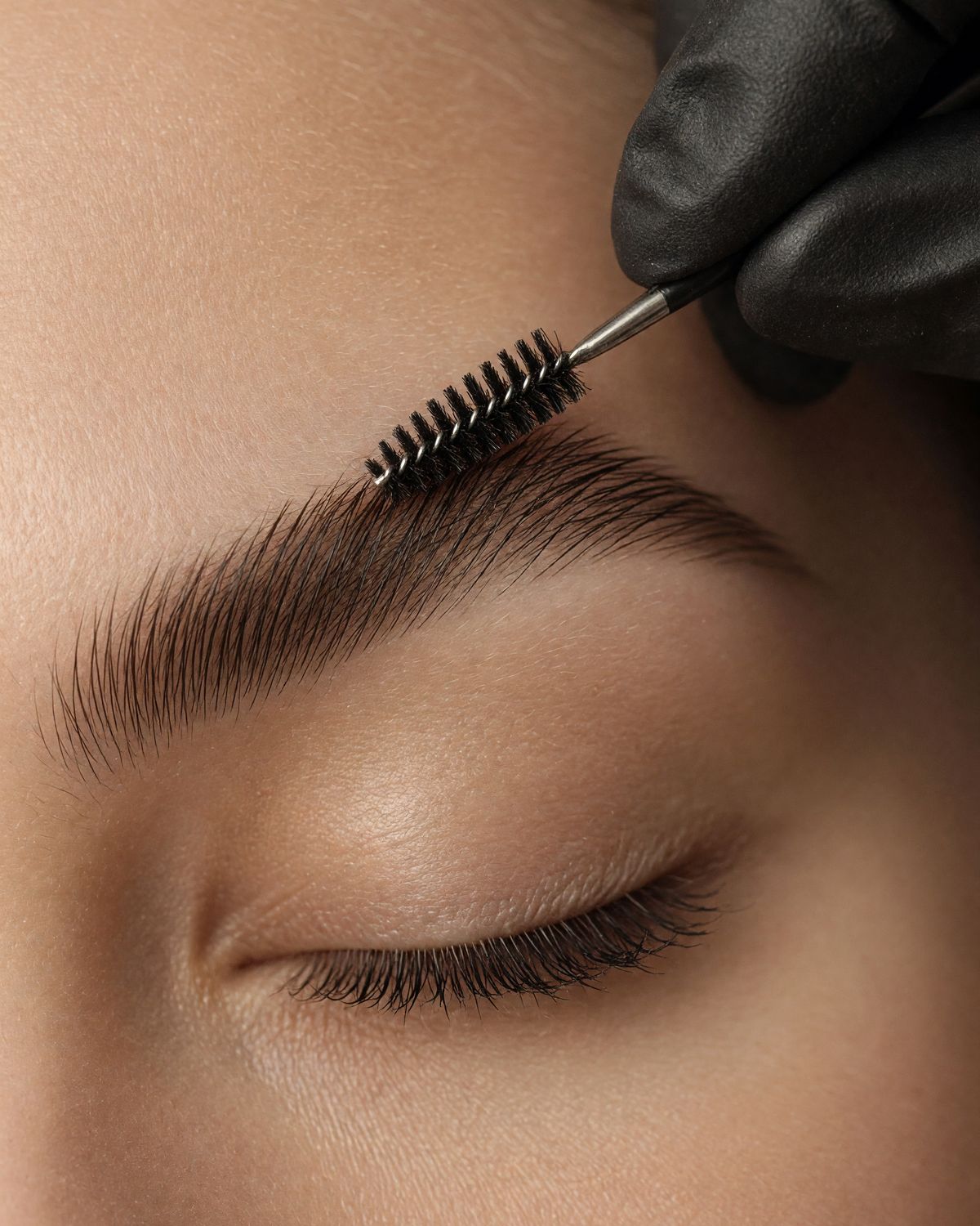An artist shaping a brow
